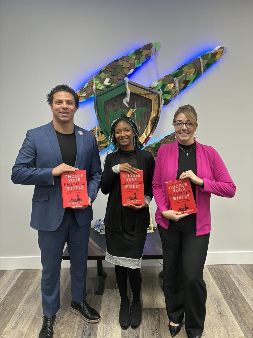 Three co-workers engaging in a reading initiative focused on career development.