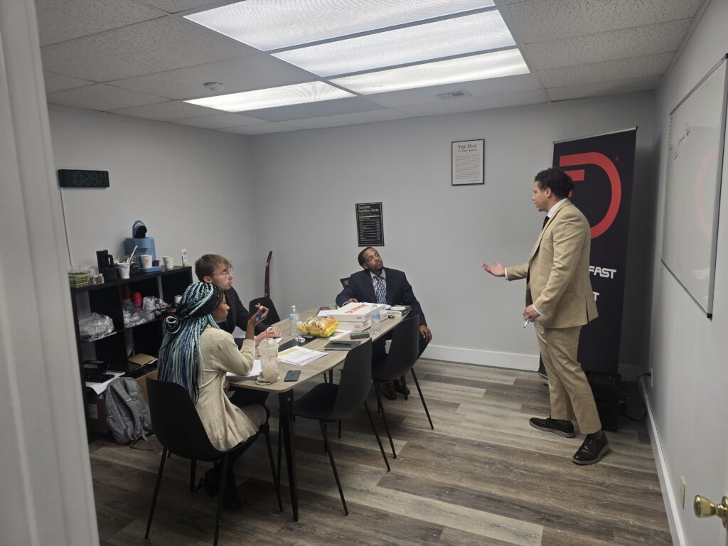 Team gathered around a table reviewing business growth strategies in the office.